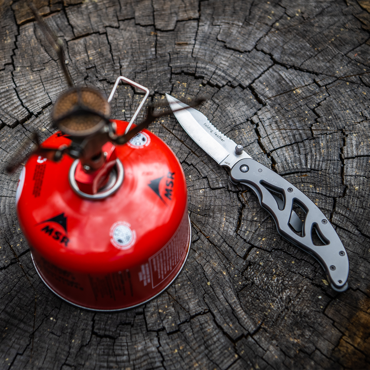 Folding Feather EDC Pocketknife next to camp stove